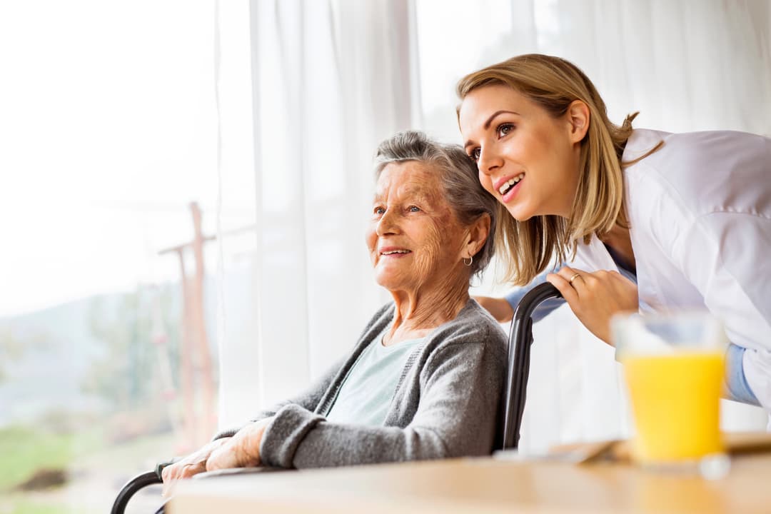 Health visitor and a senior woman during home visit