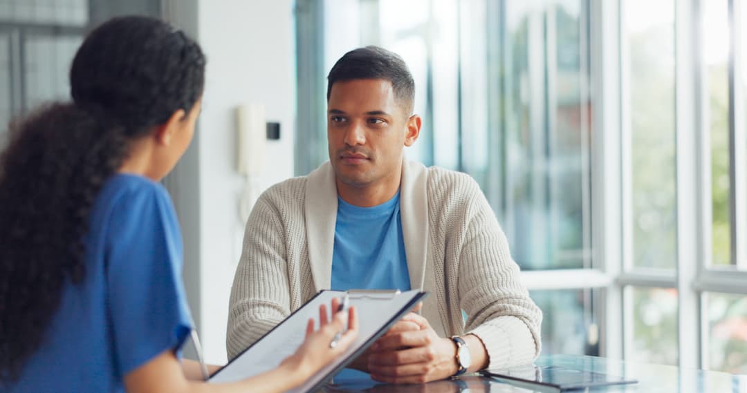 Patient consultation, clipboard and nurse doctor consulting man about health, results or hospital exam.