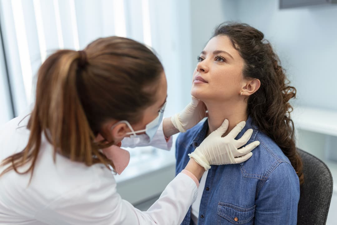 woman having thyroid checked