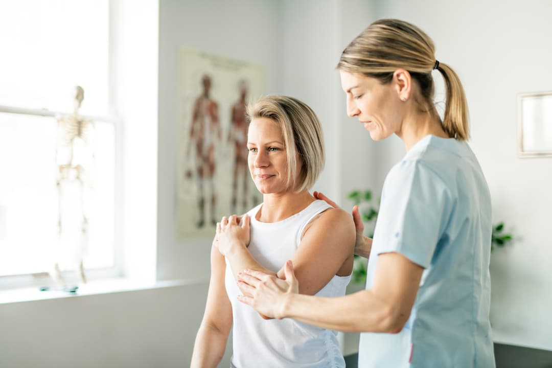 A Modern rehabilitation physical therapist with woman client