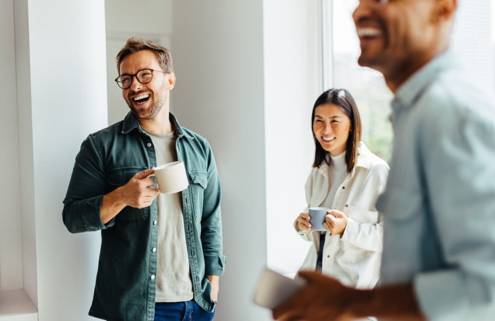 Happy business people taking a coffee break at work