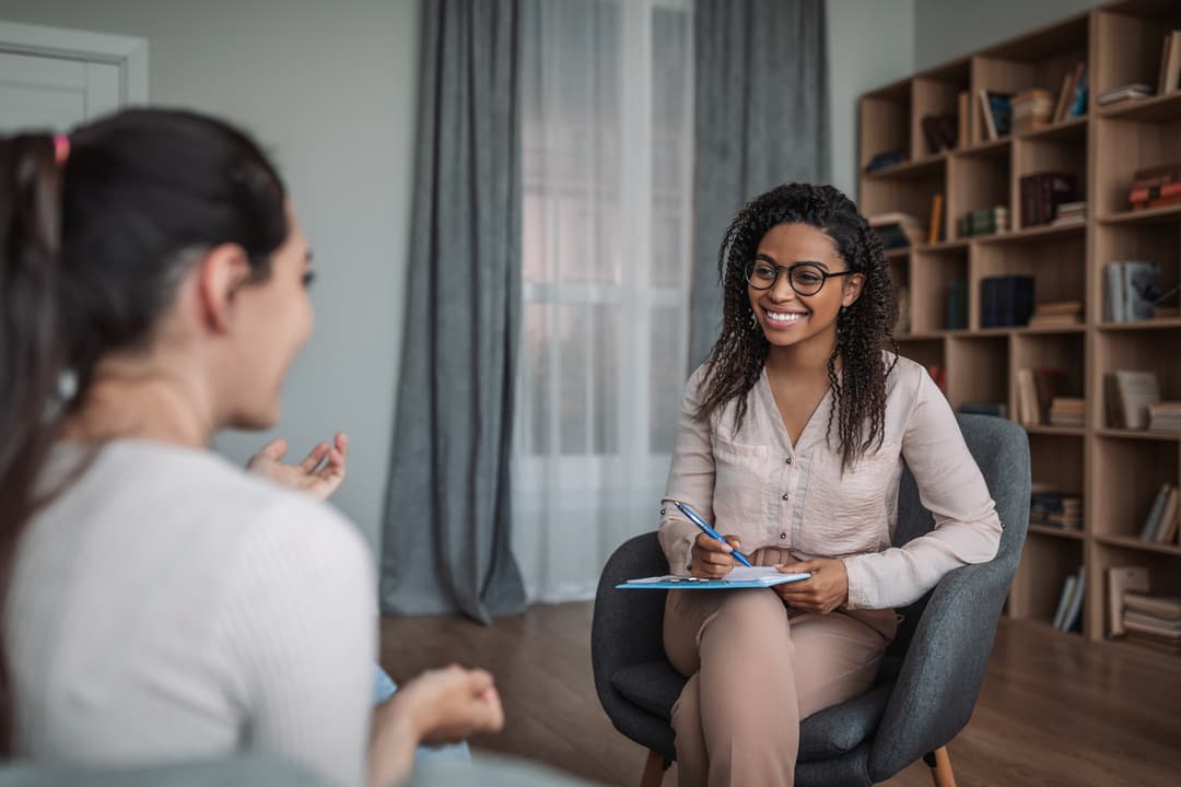 Care navigator visiting with curative health plan patient
