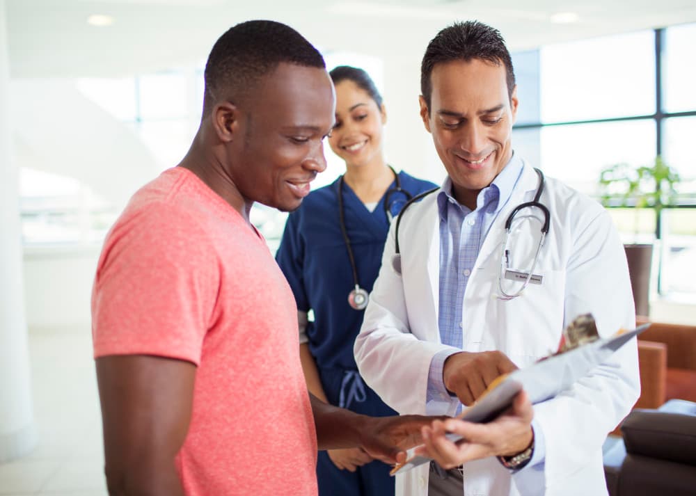 Doctor and patient reading medical chart in hospital