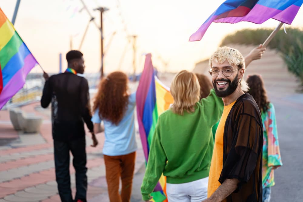 Gay rights activists with pride flag outdoors