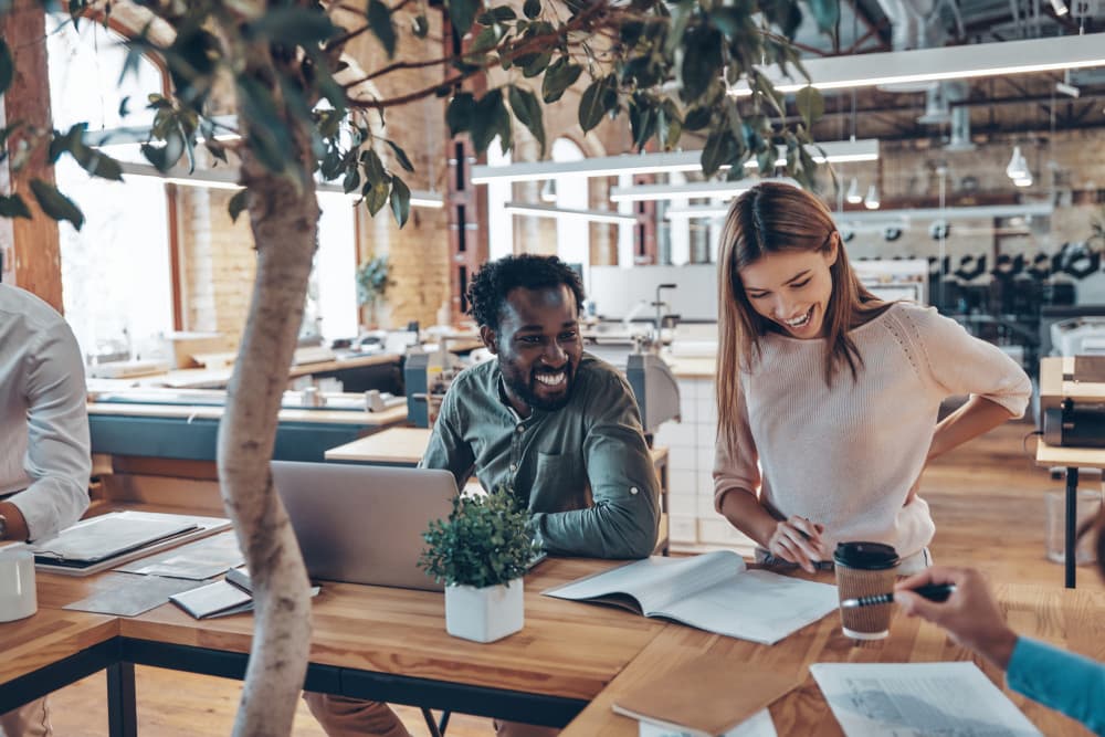 Young employees smiling in an open concept office