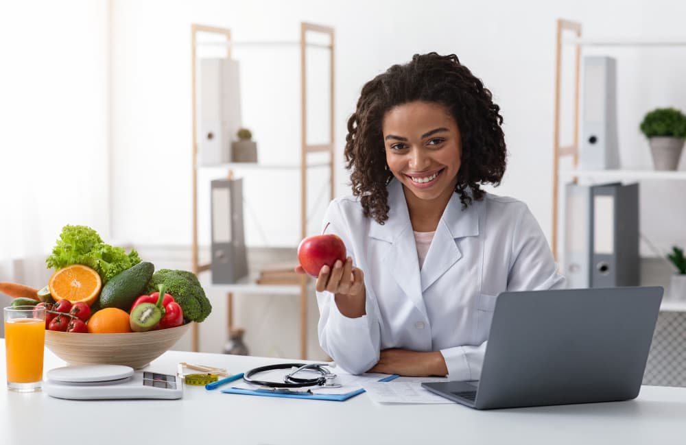 woman doctor kindly recommending eating fresh fruits