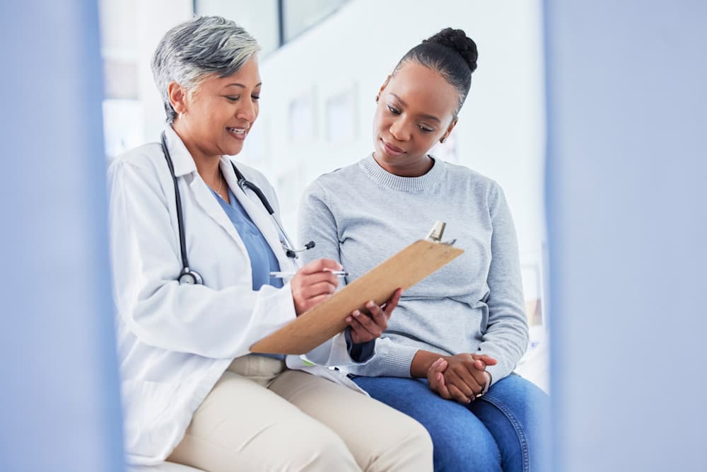 Doctor with checklist going over results with a patient