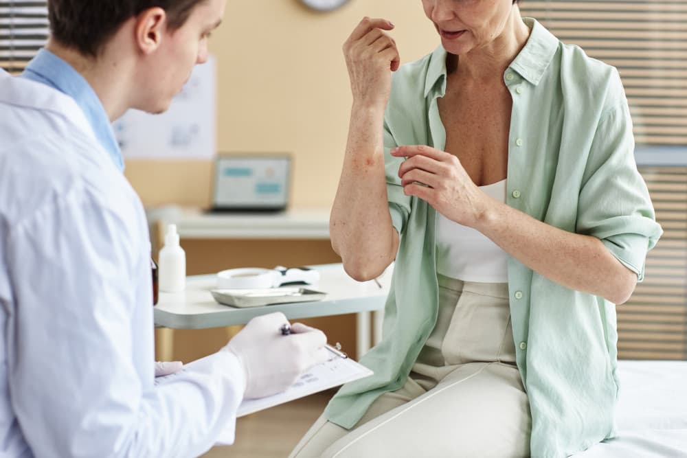 Close up of mature woman explaining symptoms of skin condition