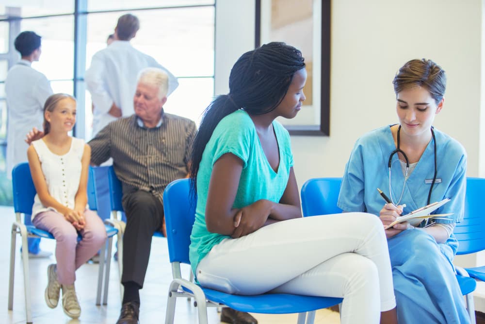 Nurse and patient talking in hospital