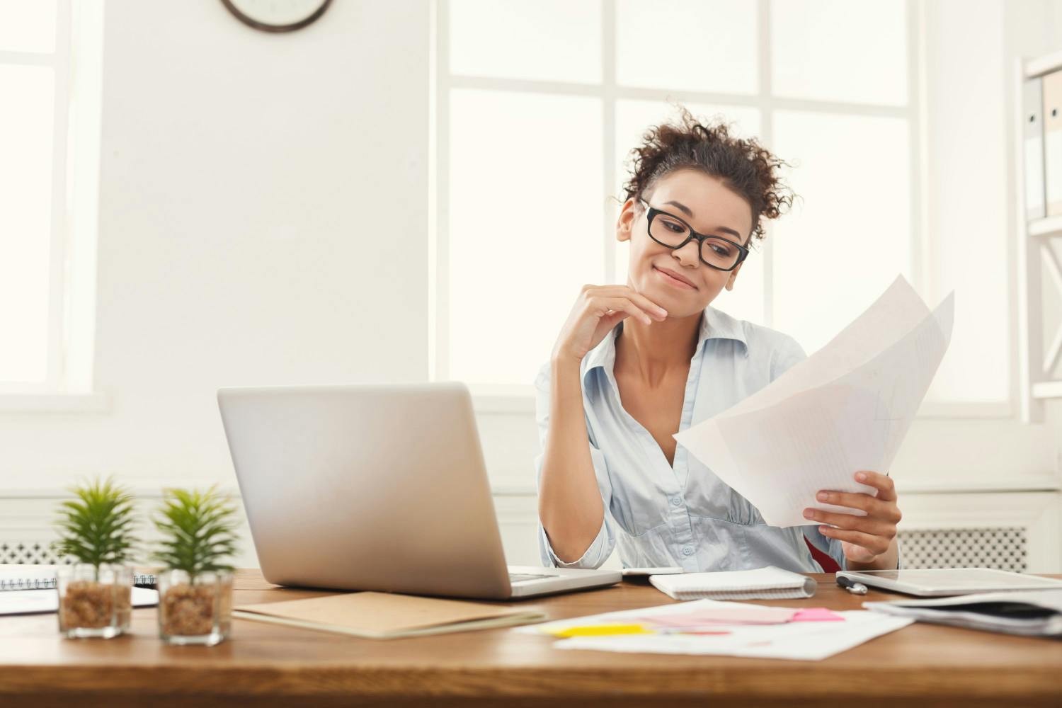 Smiling business woman reading document