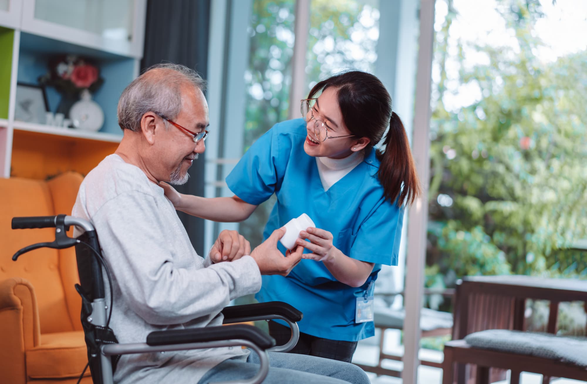 Young nurse discussing prescription with male patient in a wheel chair