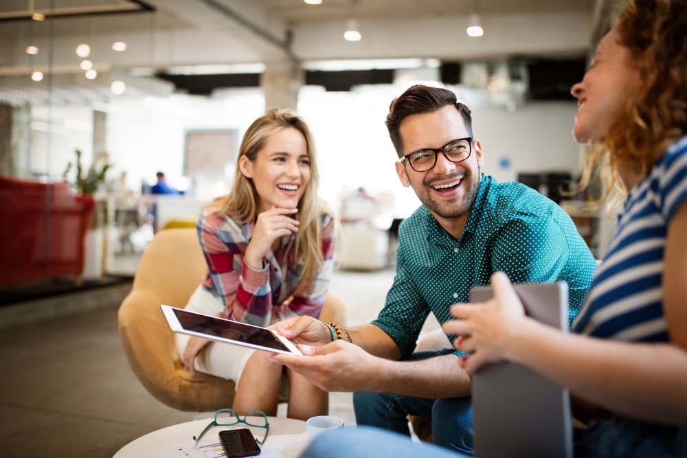 Business people brainstorming and chatting at workplace office stock