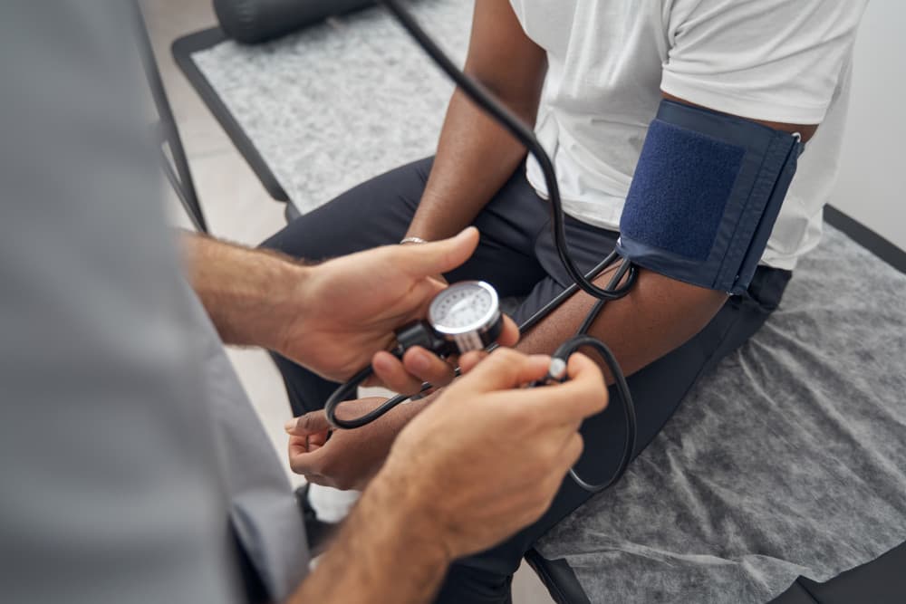 care navigator using blood pressure pump tool on curative health plan member