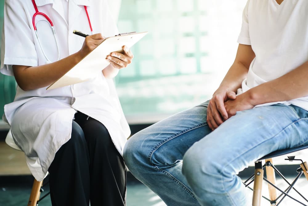Female doctor asks questions to male patient