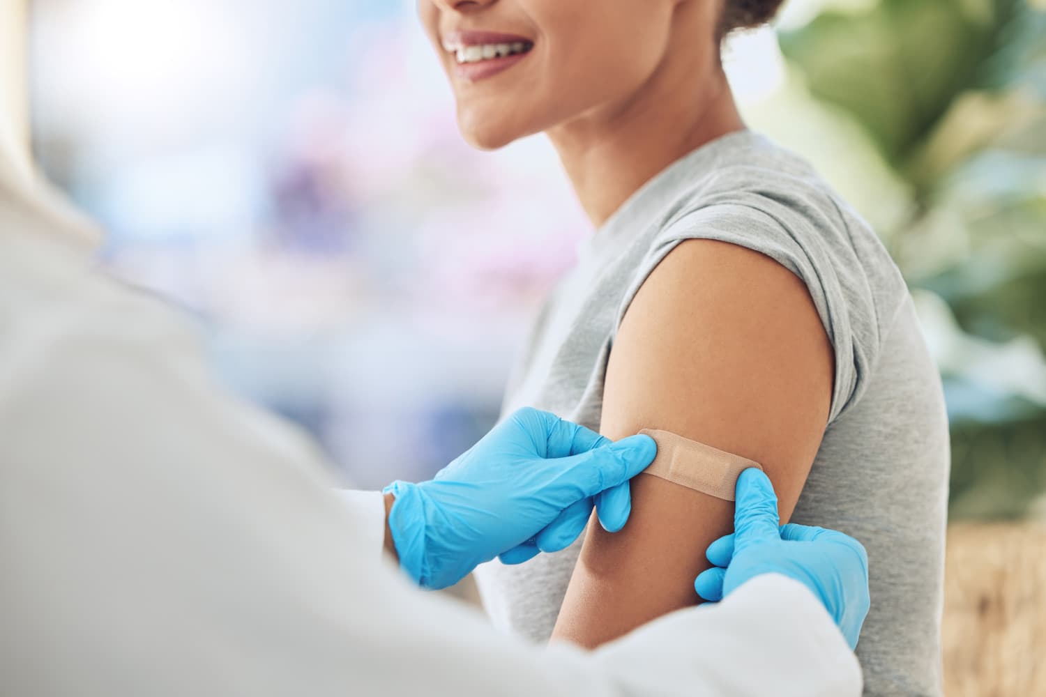 Band aid, vaccine or injection for covid and global virus in security, safety or wellness insurance. Doctor hands, medical employee or healthcare worker