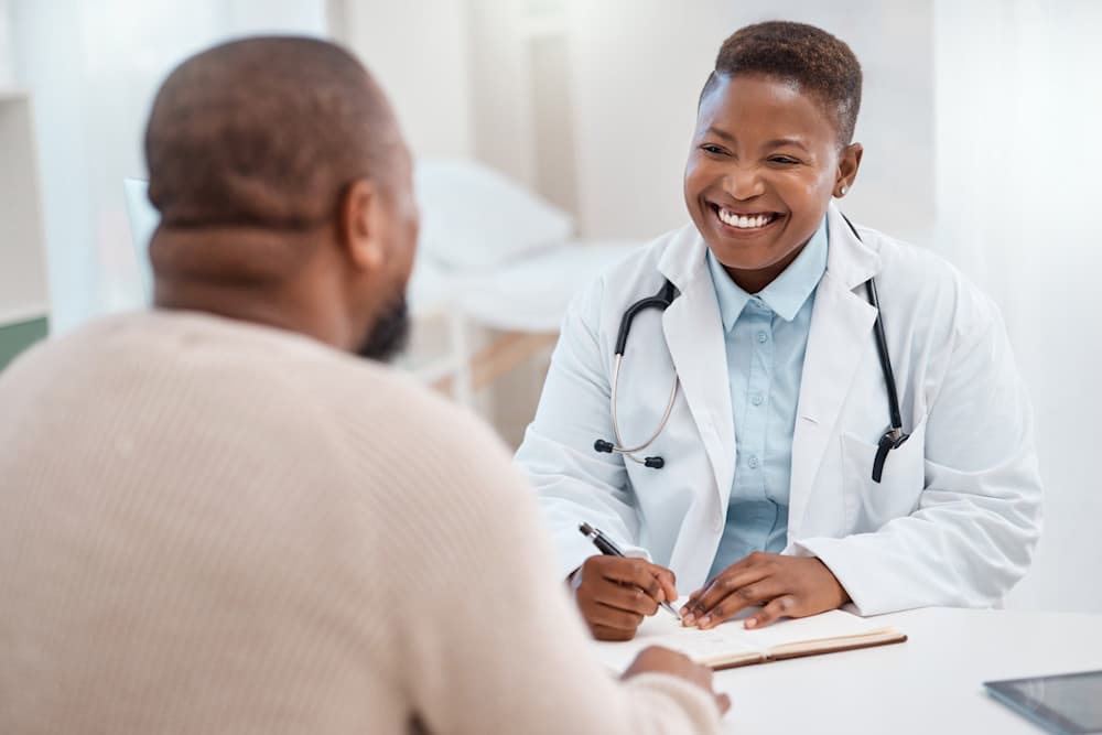 young doctor writing notes during a consultation with a patient in a medical office