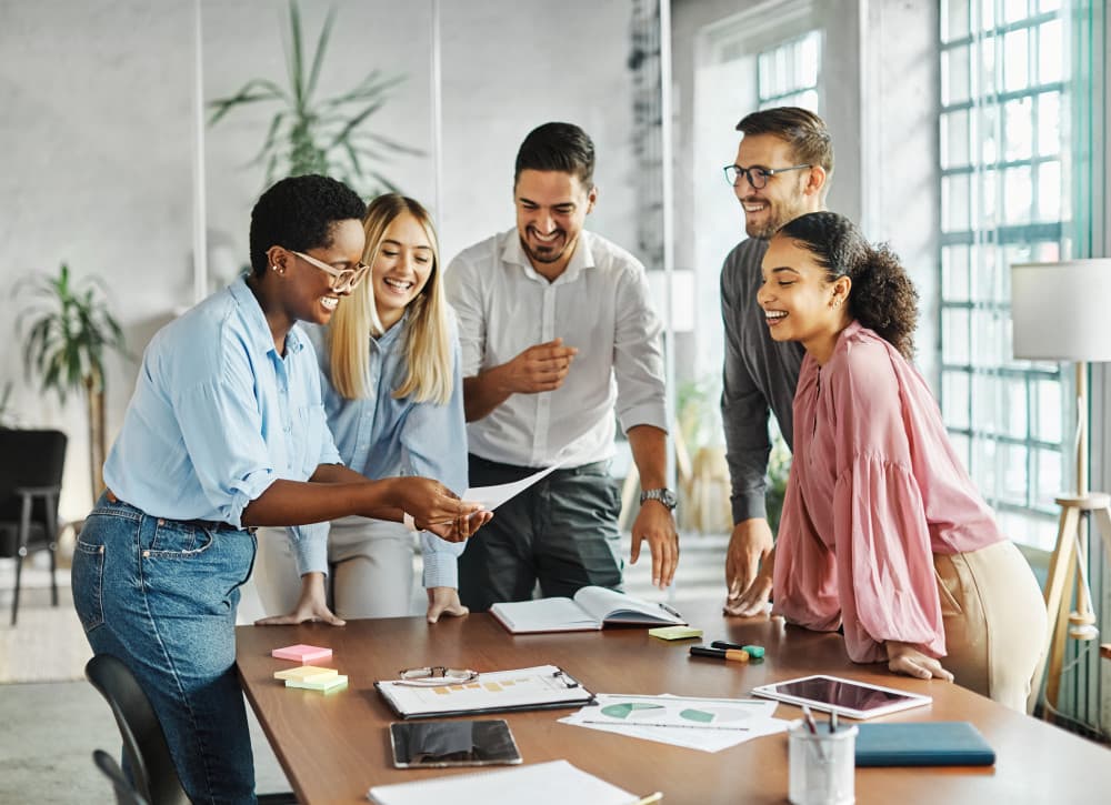 colleagues smiling around a conference room table