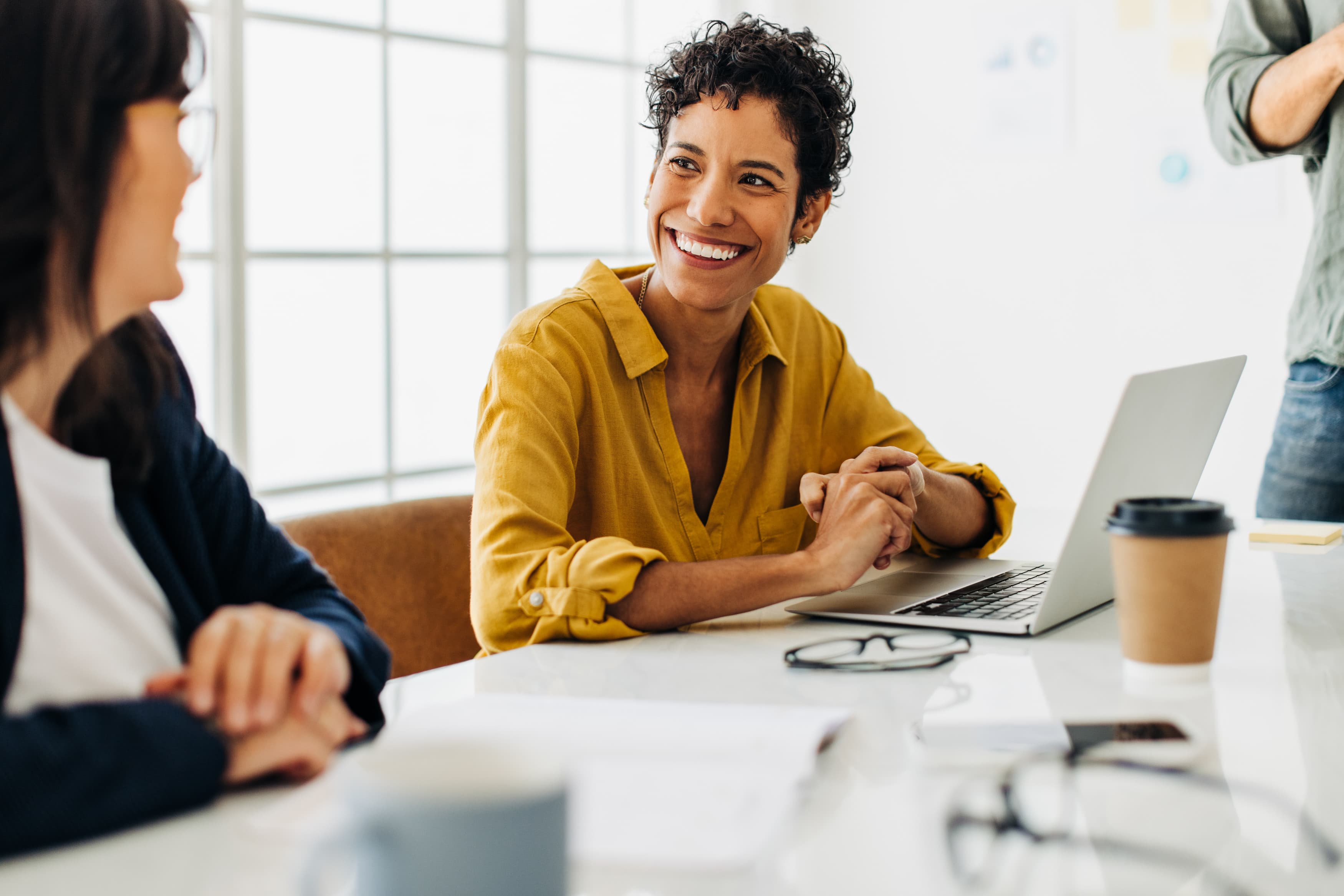 Business woman talking to her colleague during a meeting in a boardroom