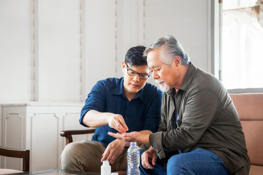 Middle aged son takes care of sick senior father