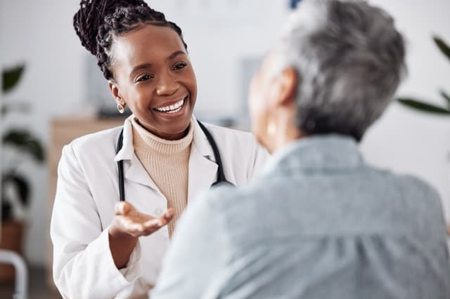 doctor consulting a patient in meeting in hospital for healthcare feedback or support.