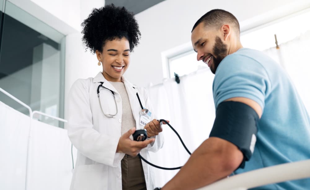 Happy doctor, patient and blood pressure for appointment